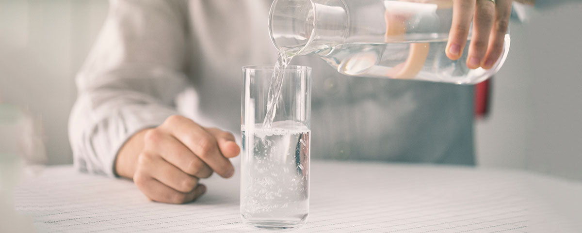 Man pouring a glass of water